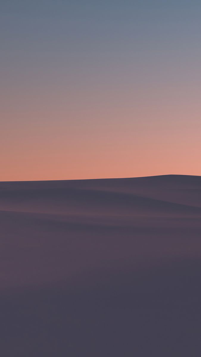 an airplane is flying in the sky at sunset or dawn with no clouds on it