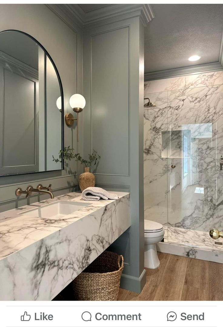 a bathroom with marble counter tops and walls