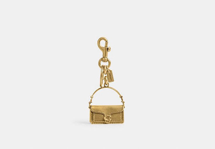 Tabby Bag Charm | COACH Rectangular Bag Charm With Key Clip, Rectangular Logo Bag Charm, Rectangular Key Leash Bag Charm For Everyday, Rectangular Bag Charm With Lobster Clasp For Everyday Use, Elegant Everyday Bag Charm With Logo, Gold Bags With Logo Charm, Gold Rectangular Keychain With Key Leash, Rectangular Keychain With Key Leash For Daily Use, Luxury Keychain With Key Clip For Gift