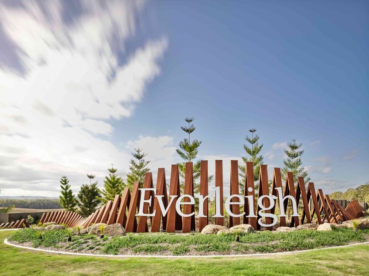 the entrance to everlight is surrounded by trees and grass