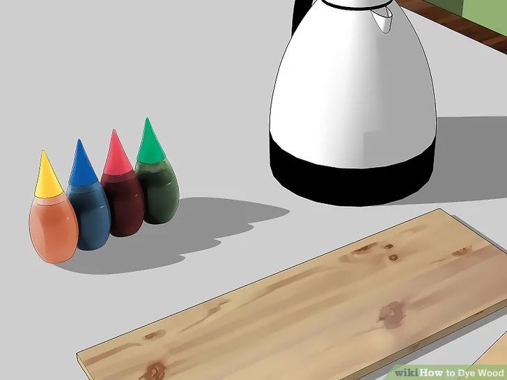 a white jug sitting on top of a table next to colored crayons and a wooden board