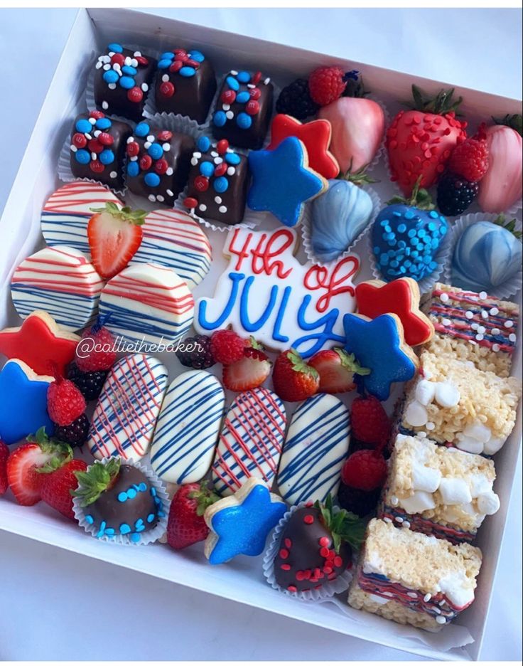 a box filled with lots of different types of cookies and strawberries on top of each other