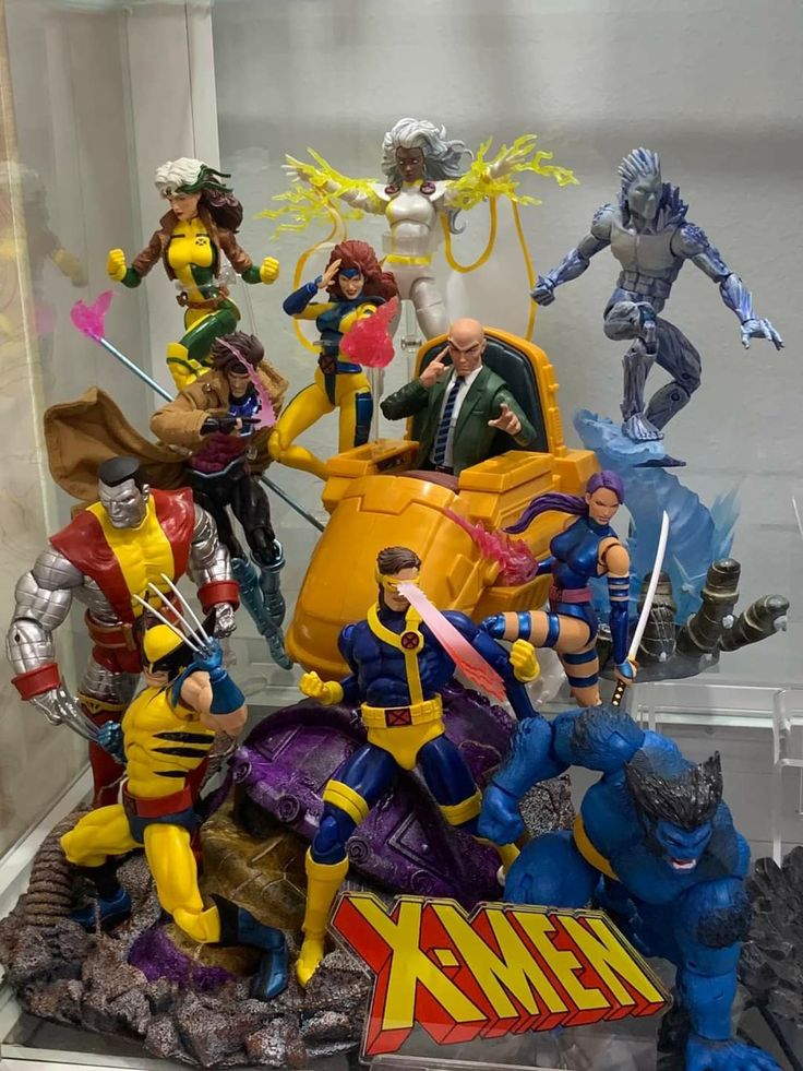 many action figures on display in a glass case at a toy store, including wolverineman and the x - men