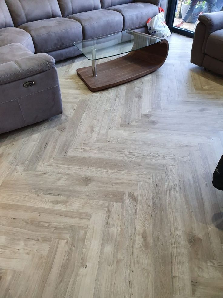 a living room filled with furniture and a glass top coffee table in the middle of it