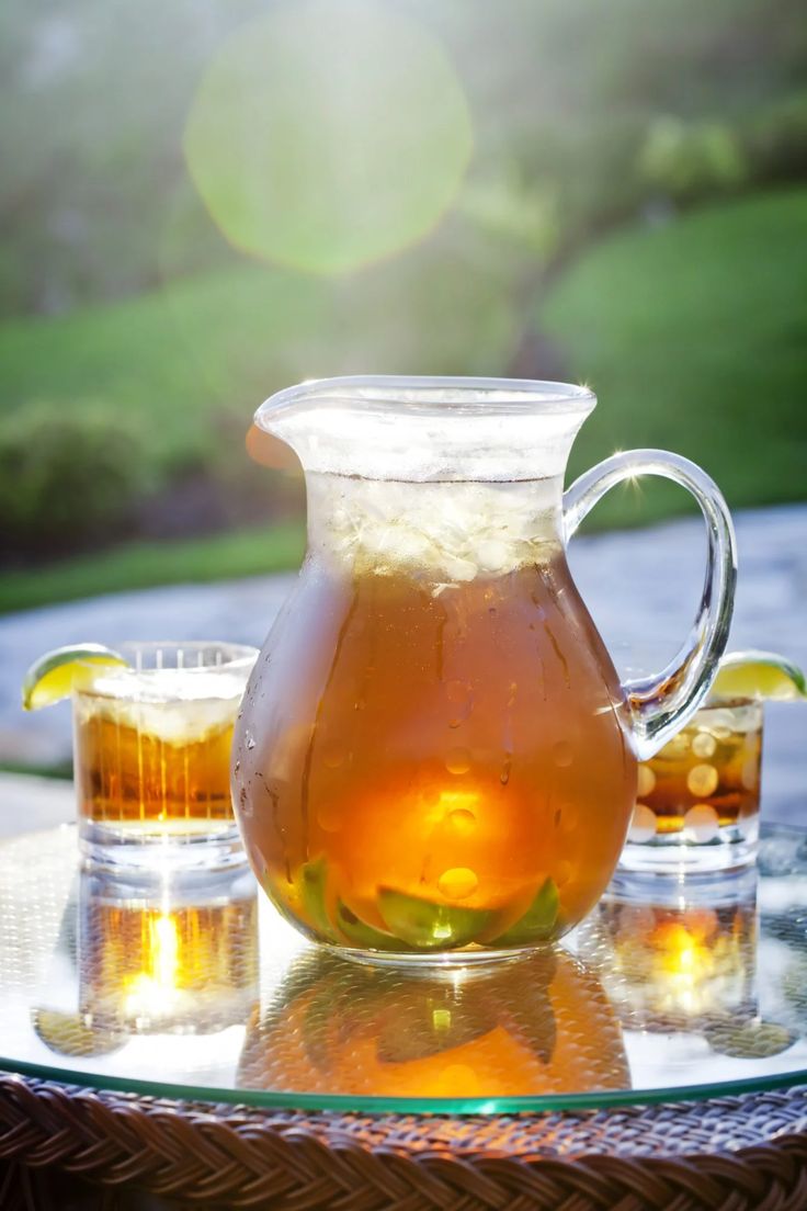 a pitcher of tea sitting on top of a glass table