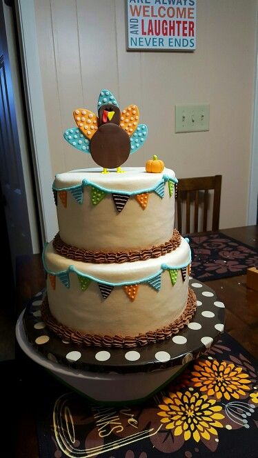 a three tiered cake with a turkey on top