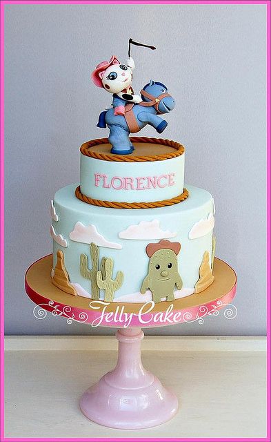 a three tiered cake decorated with an image of a cowboy on top and the words florence above it