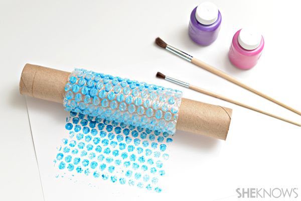 some crafting supplies are sitting on top of a paper towel and paintbrushes