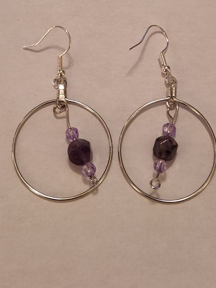 Amethyst faceted beads, lavender faceted beads, dangle from a stainless steel hoop, on stainless steel hooks. I enjoy working with my February birthstone, so I hope you will like them too. Adjustable Metal Earrings With Faceted Beads, Purple Metal Crystal Earrings As Gift, Purple Crystal Metal Earrings For Gifts, Purple Metal Crystal Earrings For Gift, Faceted Beads Dangle Hoop Earrings For Gifts, Metal Beaded Earrings With Faceted Beads For Gifts, Small Hoop Jewelry With Faceted Beads For Gifts, Purple Wire Wrapped Beaded Earrings For Gift, Hoop Jewelry With Faceted Beads For Gifts