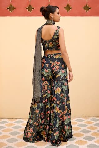 Navy blue blouse with all over floral garden prints. Paired with coordinating sharara and stole with beaded detailing. - Aza Fashions Fitted Blue Floral Print Sharara, Summer Silk Sharara With Printed Motifs, Bohemian Silk Sharara With Floral Print, Multicolor Fitted Sleeveless Sharara, Summer Floral Print Sharara, Sleeveless Sharara With Floral Embroidery For Summer, Bohemian Sleeveless Sharara For Summer, Sleeveless Floral Embroidered Sharara For Summer, Summer Floral Embroidery Sharara