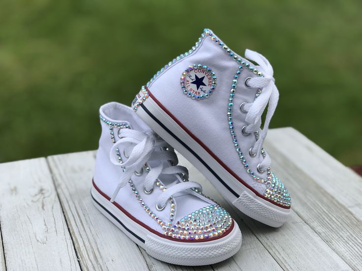 White Converse Touch of Bling Sneakers Little Kids Shoe Size 10-2 These authentic white Converse have a touch of bling on the toe, Converse emblem and back of the shoe. Information about the shoes All sneakers are Converse brand and have a mix of hand applied high quality glass crystals and resin flat-backs. Please select your color choice by the available drop down options, an option of all glass crystals no color is also available. Converse sizing is unique and sneaker specific. Converse Kids White Bling Lace-up Sneakers, Low-top White Sneakers With Bling, White Low-top Sneakers With Bling, White High-top Sneakers With Rhinestones, White Rhinestone Round Toe Sneakers, Ladybug Tutu, Bling Sneakers, Converse Collection, Purple Converse