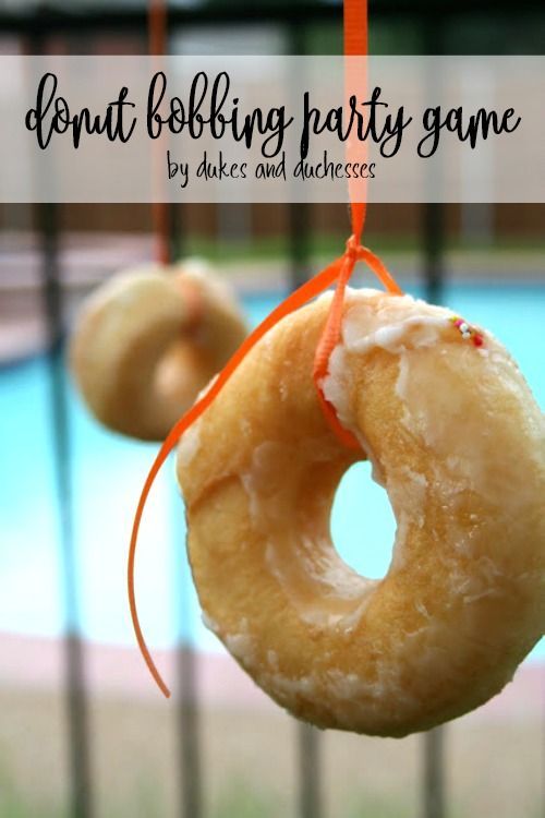 two donuts hanging from strings near a swimming pool