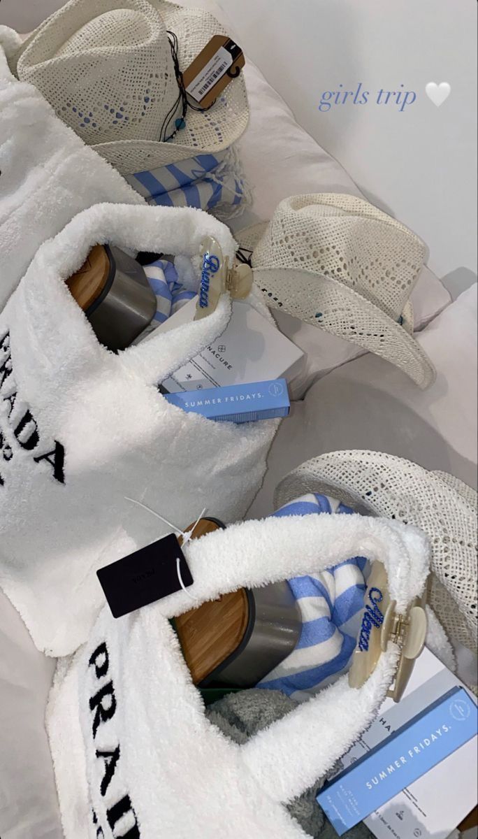 several pairs of shoes are lined up on a bed with white and blue striped covers