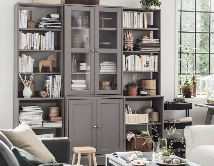 a living room filled with furniture and bookshelves