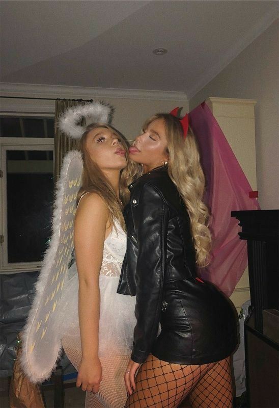 two women dressed in costumes kissing each other