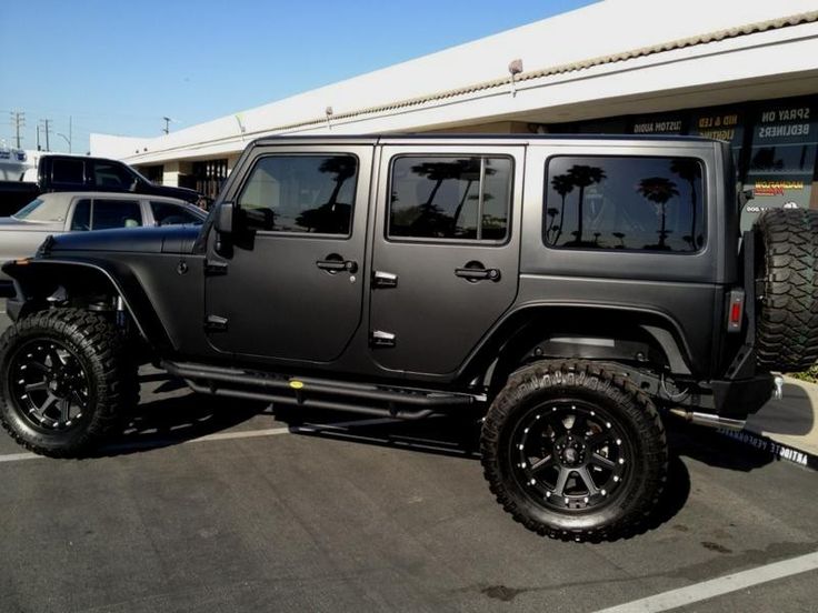 a black jeep parked in front of a building