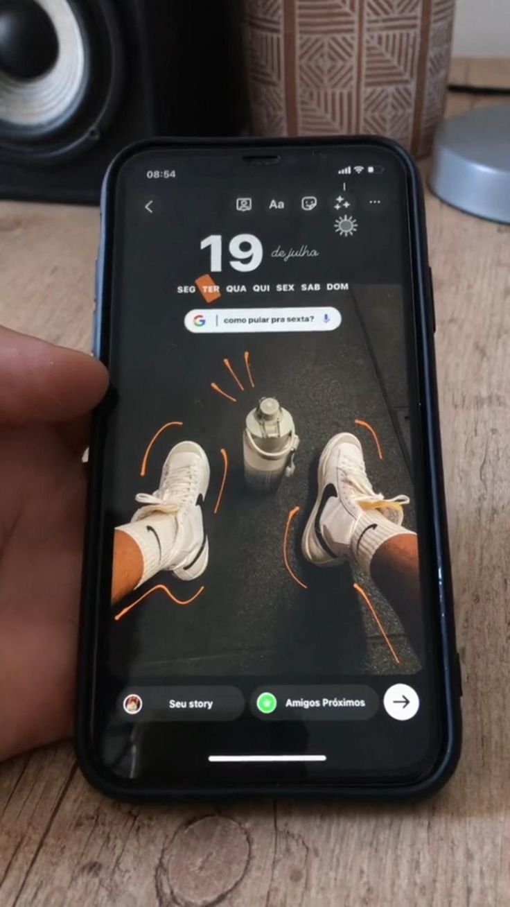 someone is holding their cell phone with an image of two pairs of shoes on the screen