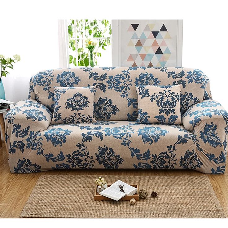 a blue and white couch sitting on top of a wooden floor next to a rug