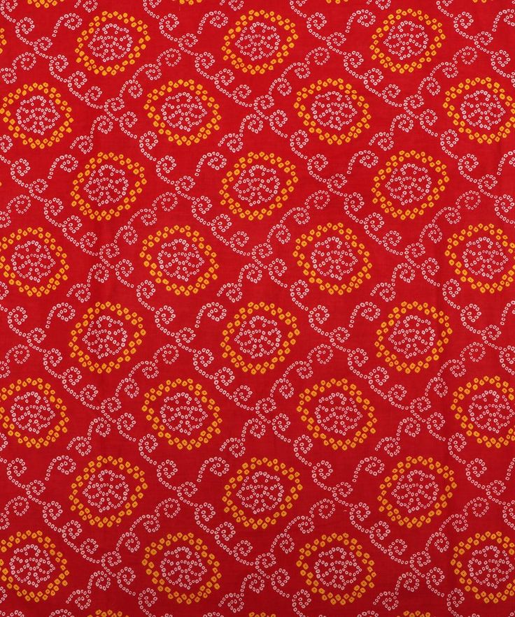 an orange and red paisley print fabric with white dots on it's edges,