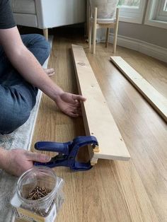 a person sitting on the floor with some tools