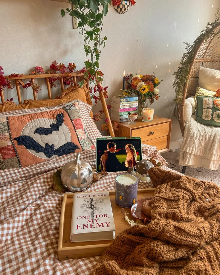 a bed room with a neatly made bed and a laptop on the end table next to it