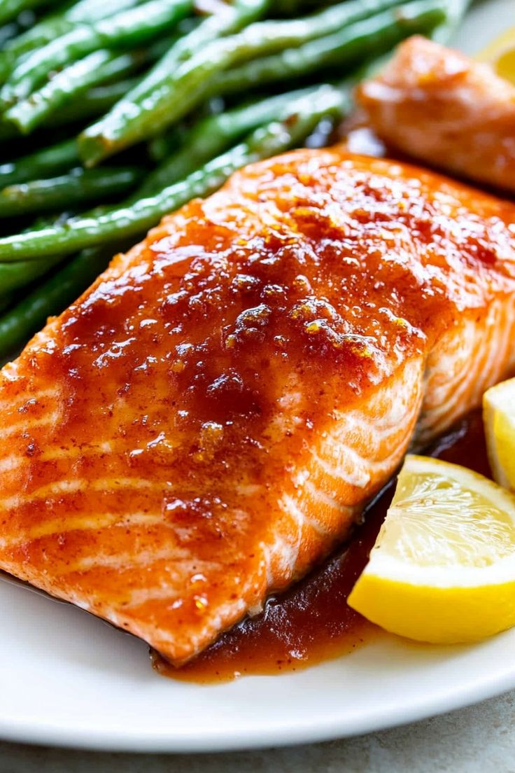 salmon, asparagus and lemon slices on a white plate