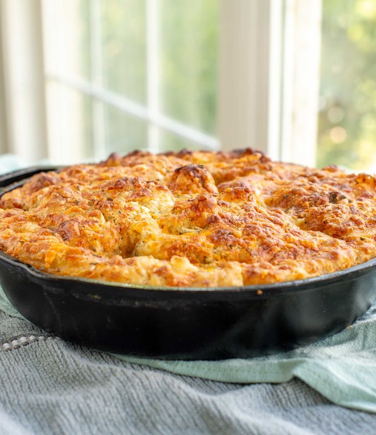 a casserole dish sitting on top of a table next to a glass window