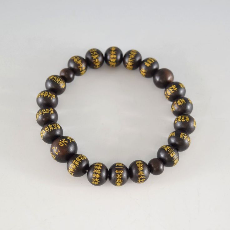 Japanese Black Ebony Wood Heart Sutra Beads Bracelet Characteristics of the product Material : Ebony wood, Silk elastic cordLength : about 17cm/18cmMain beads : about 10mmHead bead : about 13mm Each bead of this bracelet has Heart Sutra inscribed. Handmade in Kyoto, JAPAN About ebony Ebony is a dense black / brownish hardwood, dense enough to sink in water. It is finely-textured and has a very smooth texture when polished, making it valuable as an ornamental wood. It makes a perfect gift or souv Ornamental Wood, Heart Sutra, Kumihimo Bracelets, Traditional Ceramics, Amber Bracelet, Wood Hearts, Ebony Wood, Kyoto Japan, Beads Handmade