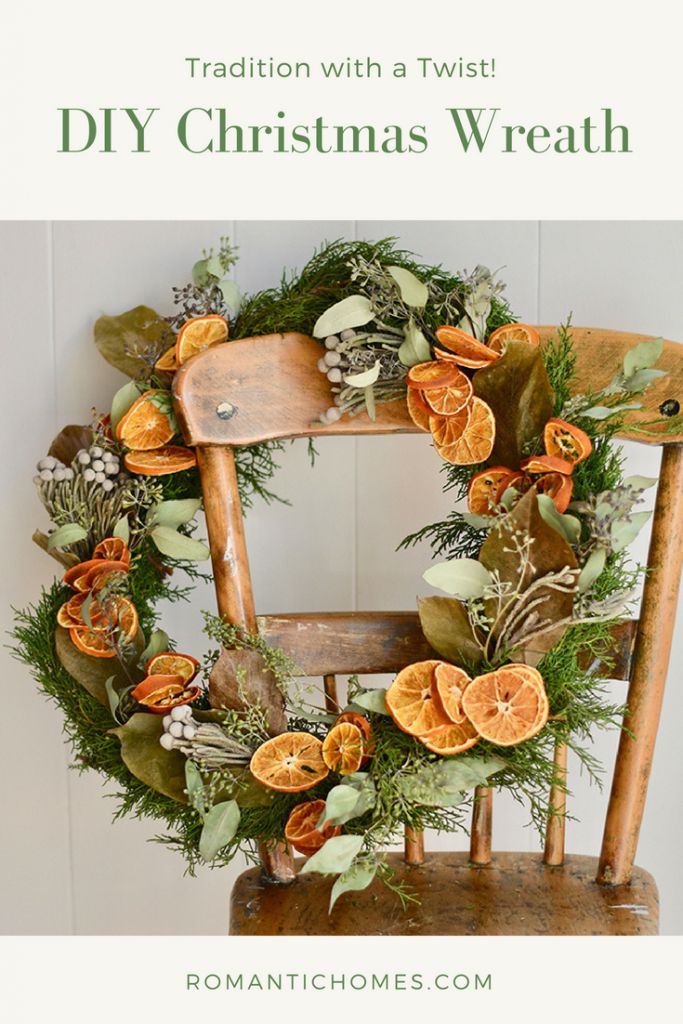 an old wooden chair with a wreath on the back and oranges attached to it