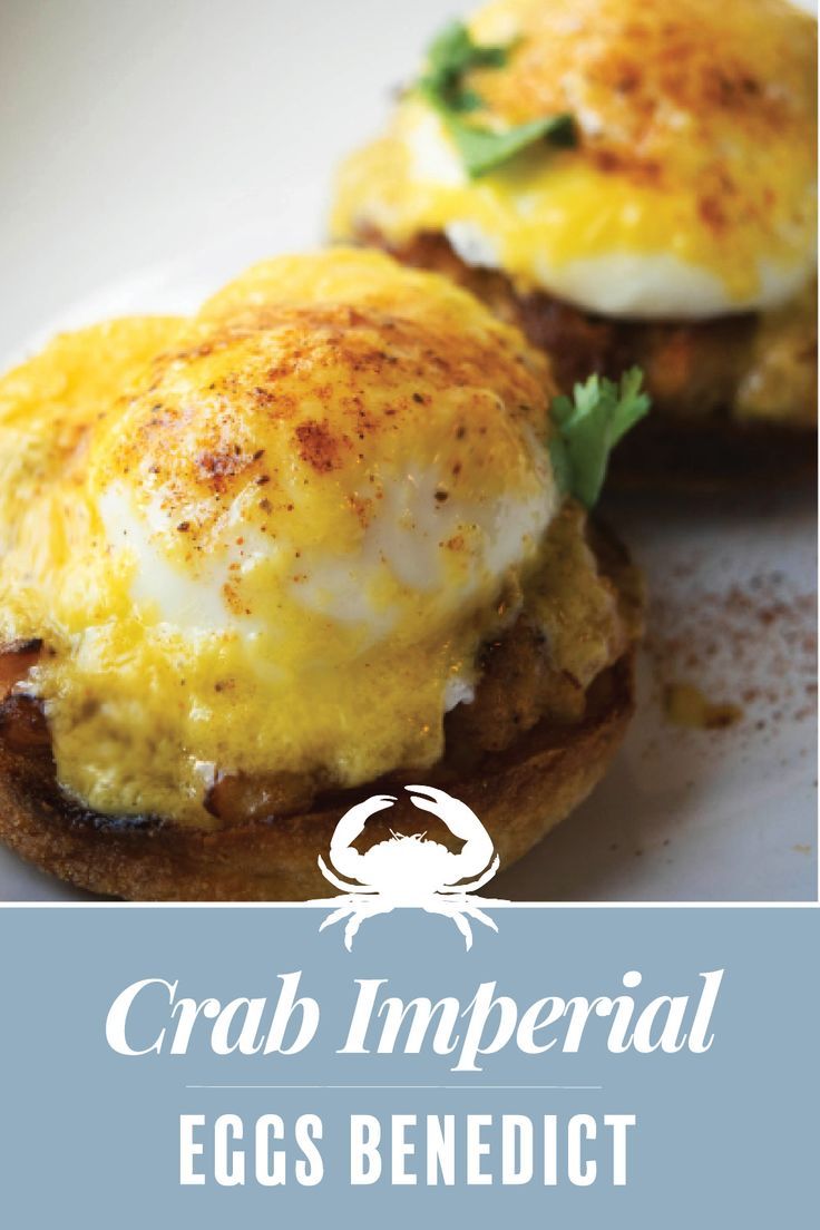 crab imperial eggs benedict on toasted english muffins with an egg and parsley garnish