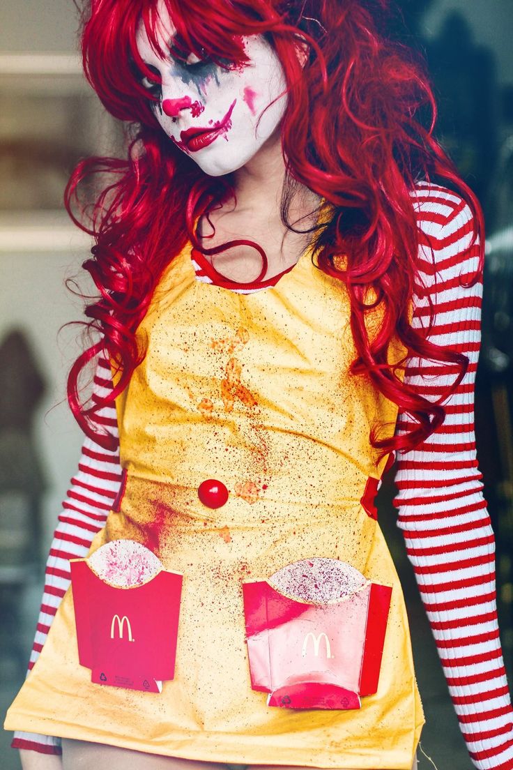 a woman with red hair and makeup is dressed as a mcdonald's chick costume