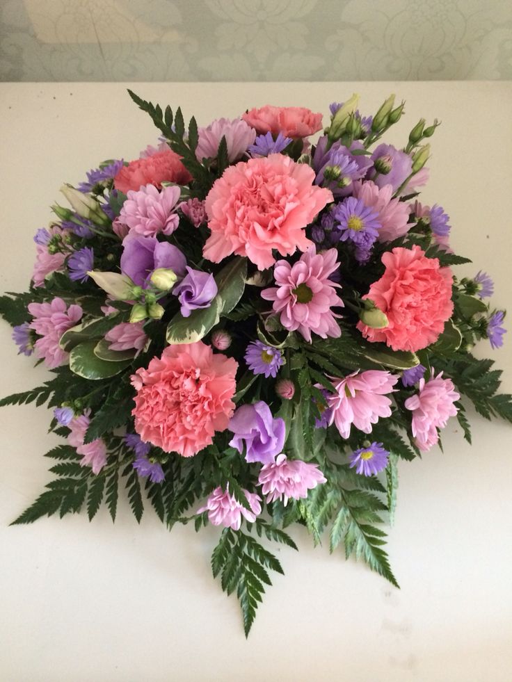 a bouquet of pink and purple flowers on a table