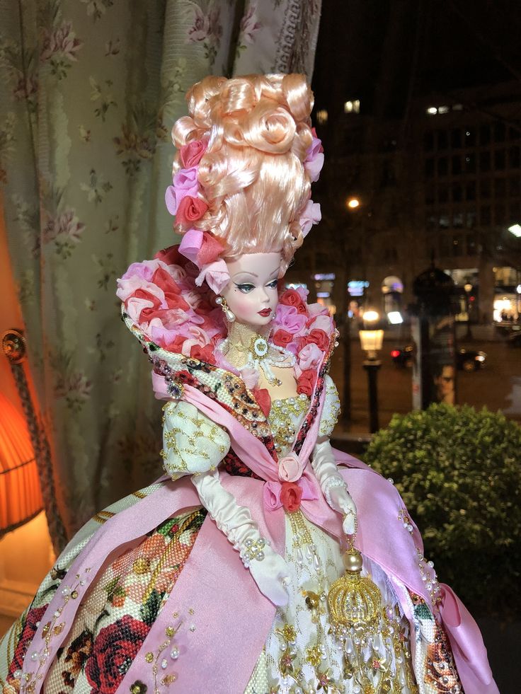 a close up of a doll in a dress