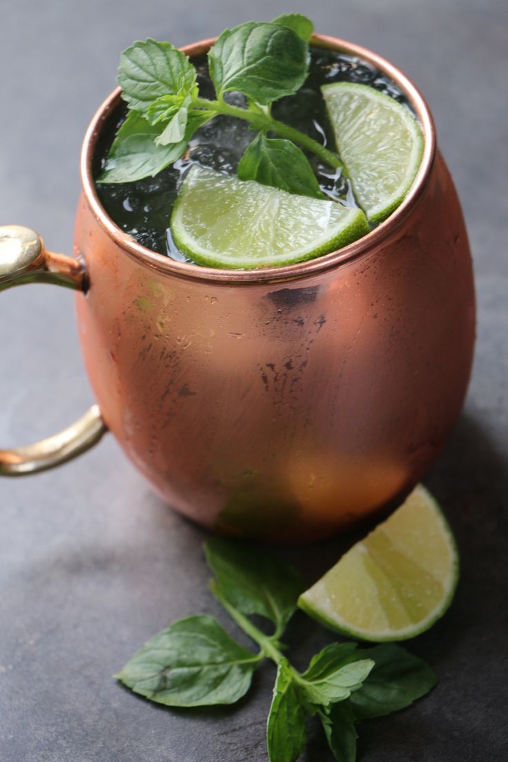 a copper cup filled with mint and lime