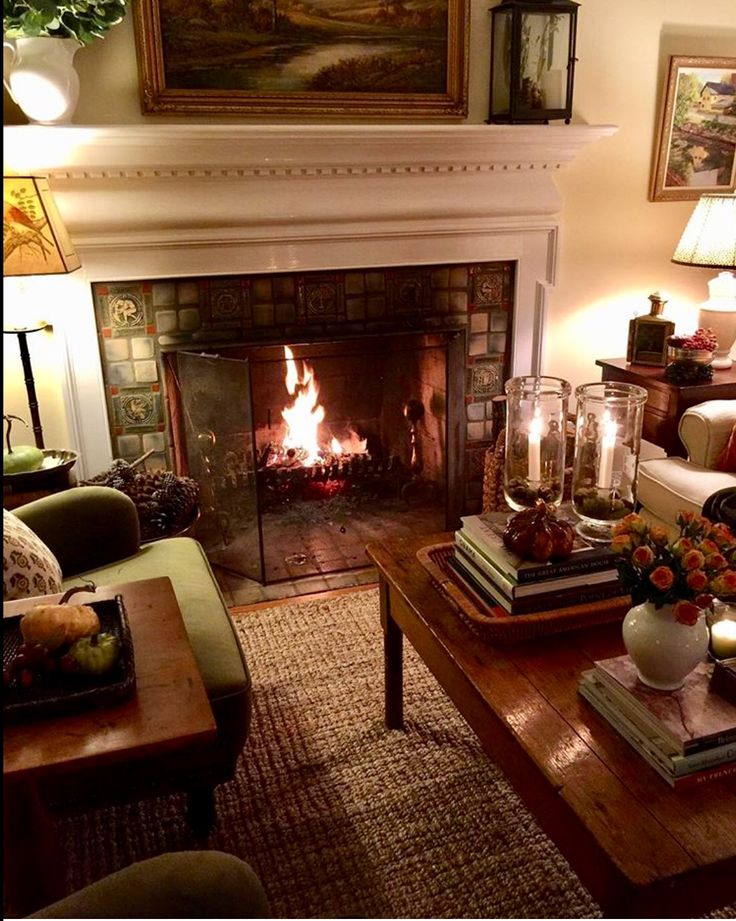 a living room filled with furniture and a fire place next to a painting on the wall