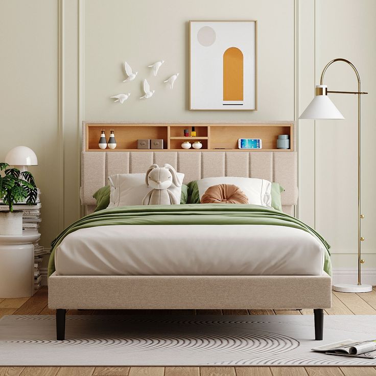 a bedroom with a bed, lamp and pictures on the wall above it's headboard