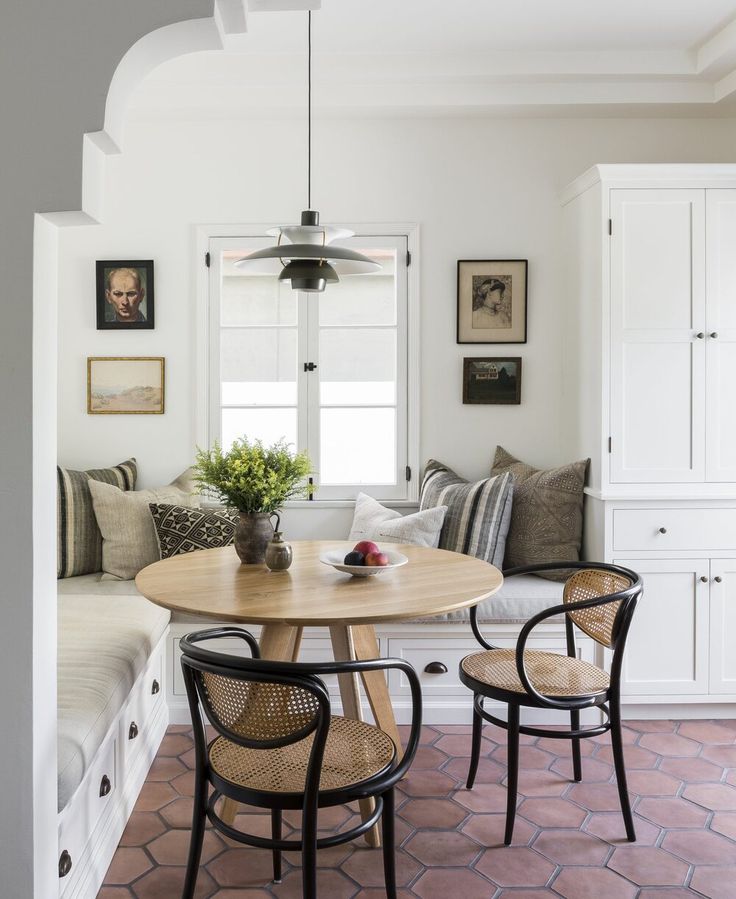 a dining room table with chairs and a bench