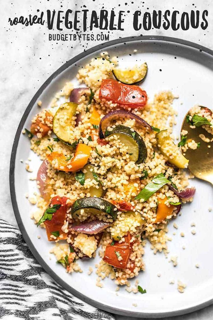 a white plate topped with couscous and vegetables