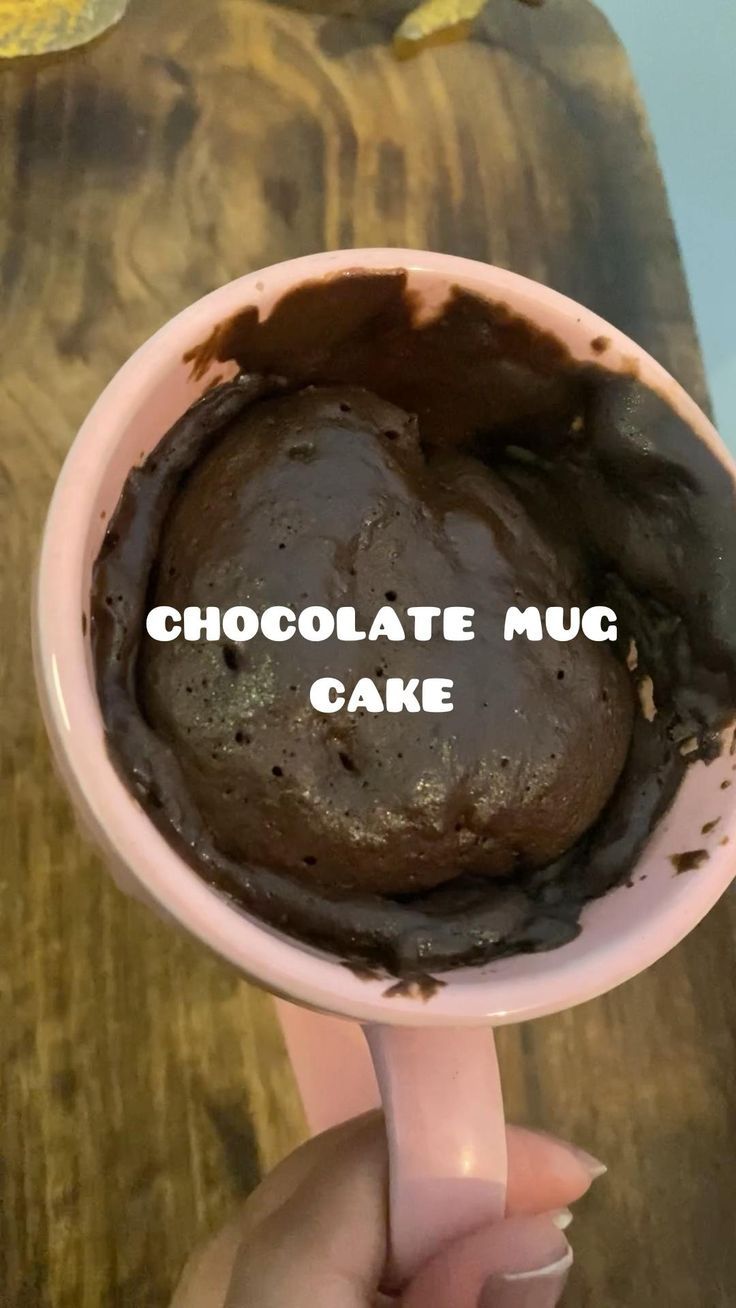 a person holding a cup filled with chocolate mud