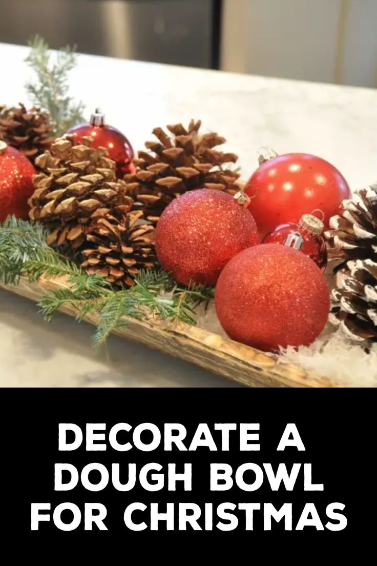 How to Decorate a Dough Bowl for Christmas How To Decorate A Wooden Trough, Bread Bowls Decor, Christmas Decor Ideas Dough Bowl, Wooden Dough Bowl Christmas Centerpiece, Wooden Bowl Filler Ideas, Dough Bowl Decor Christmas, Wooden Bowls Decor Ideas Christmas, Christmas Dough Bowls Centerpieces, Glass Bowl Decor Ideas Centerpieces Christmas Ornament