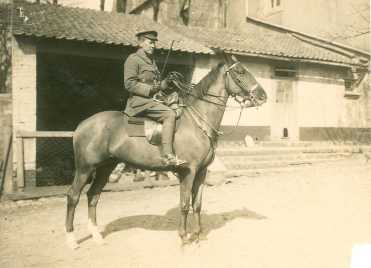 an old black and white photo of a man on a horse