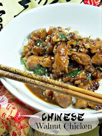 a white plate topped with meat and rice next to chopsticks