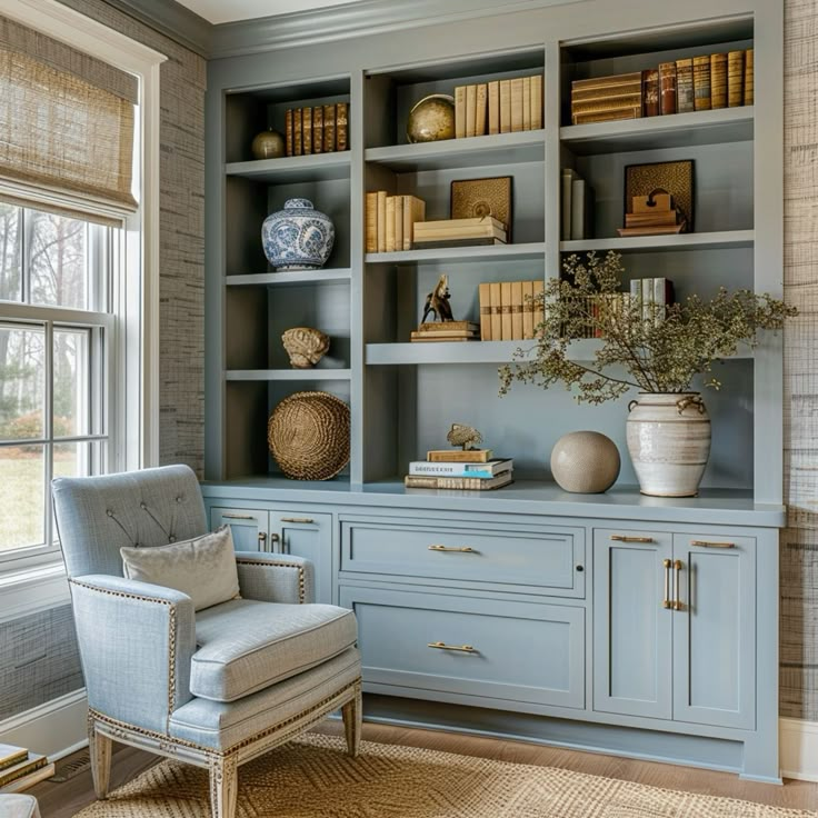 a blue bookcase with many books and vases on it in front of a window