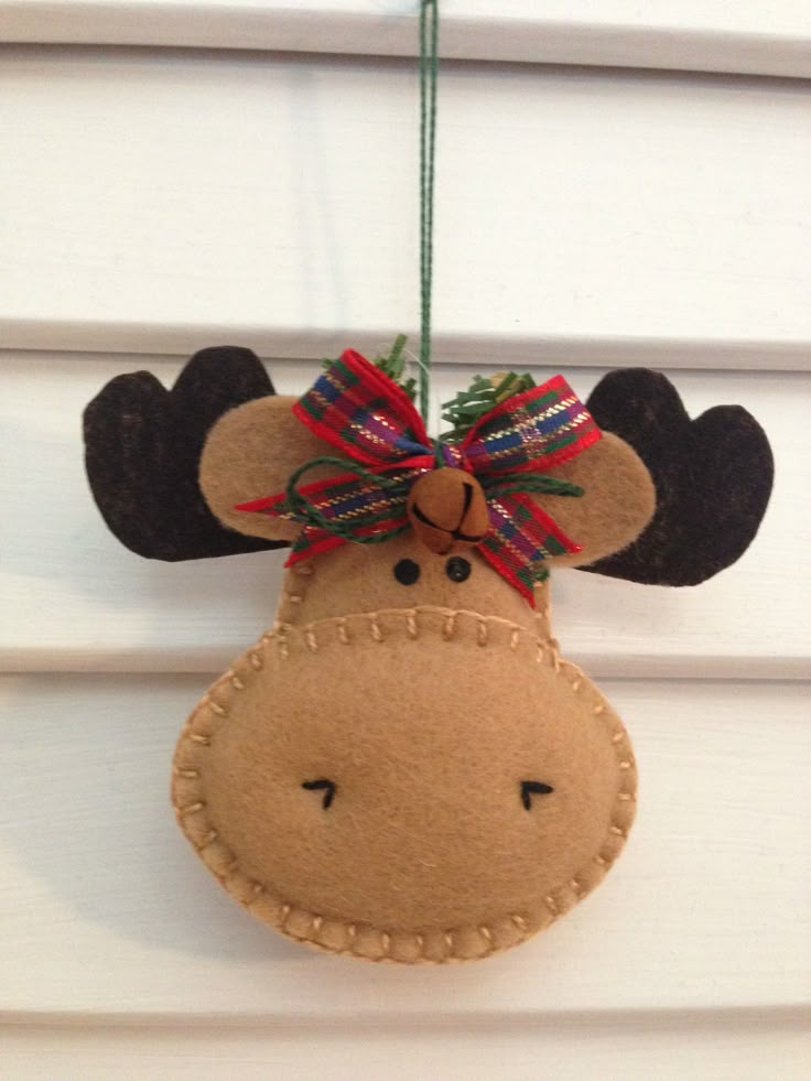 a moose ornament hanging from the side of a house