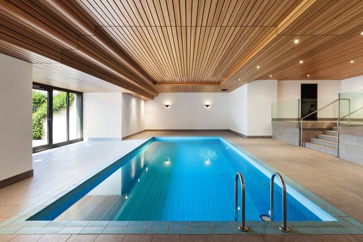 an indoor swimming pool with steps leading up to it