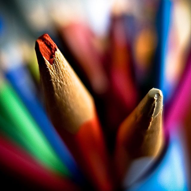 close up view of colored pencils with blurry image in the backgroud