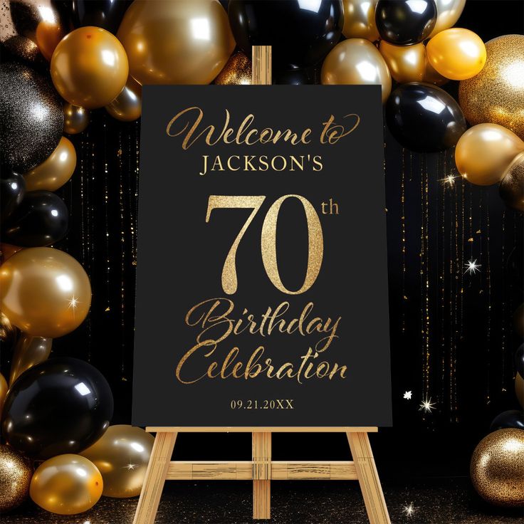 a black and gold 70th birthday celebration welcome sign with balloons in the background for guests