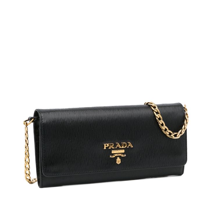 This Prada wallet on chain is made of black textured Vitello Move leather. The Bag features gold-tone details, a gold-tone chain strap, a flap with snap closure, and a zippered compartment and slip pockets for cards inside. The Bag is best across the body or loosely over the shoulder. Luxury Crossbody Wallet On Chain With Branded Hardware, Luxury Leather Wallet On Chain With Gold-tone Logo, Luxury Timeless Wallet On Chain With Gold-tone Hardware, Luxury Women's Wallet On Chain With Gold-tone Logo, Luxury Classic Gold Wallet On Chain, Luxury Designer Women's Wallet On Chain, Luxury Gold Wallet On Chain, Luxury Gold Classic Wallet On Chain, Luxury Elegant Gold Wallet On Chain