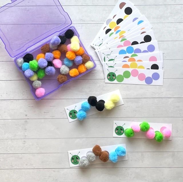 several different colored pom poms are on the table