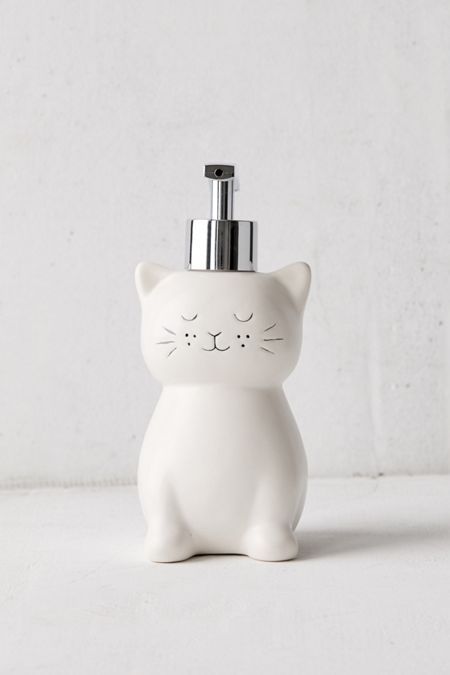 a white cat soap dispenser on a table